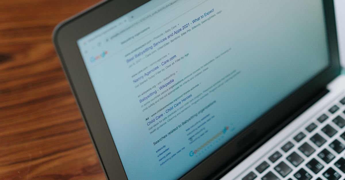Marketer reviewing search engine optimization results on a laptop
